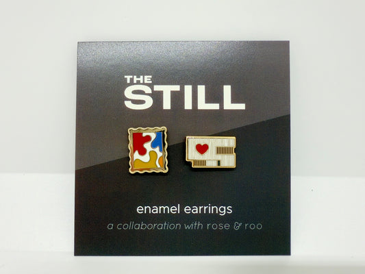 Enamel earrings of the Clyfford Still Museum building and a painting