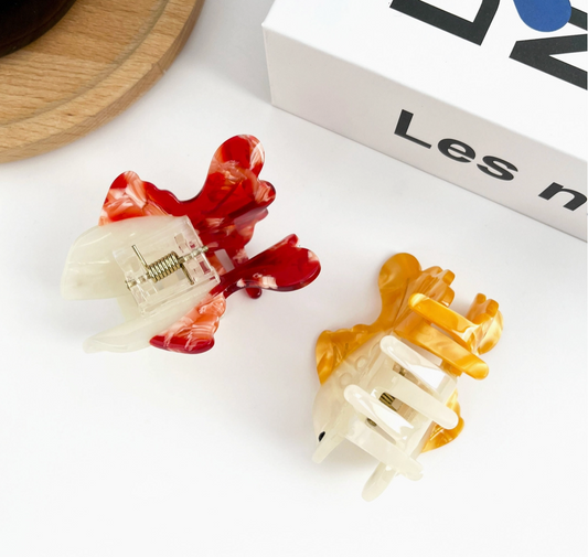 Two colorful hair clips on a white.