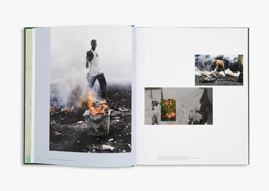 Open book displaying black and white photographs of a person near a fire.