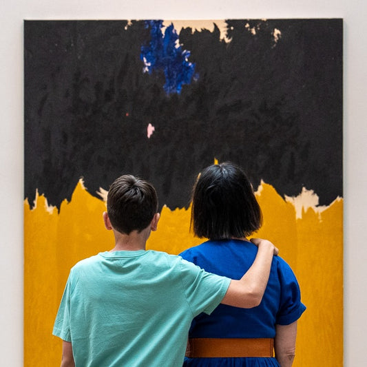 Two people standing in front of Clyfford Still painting 