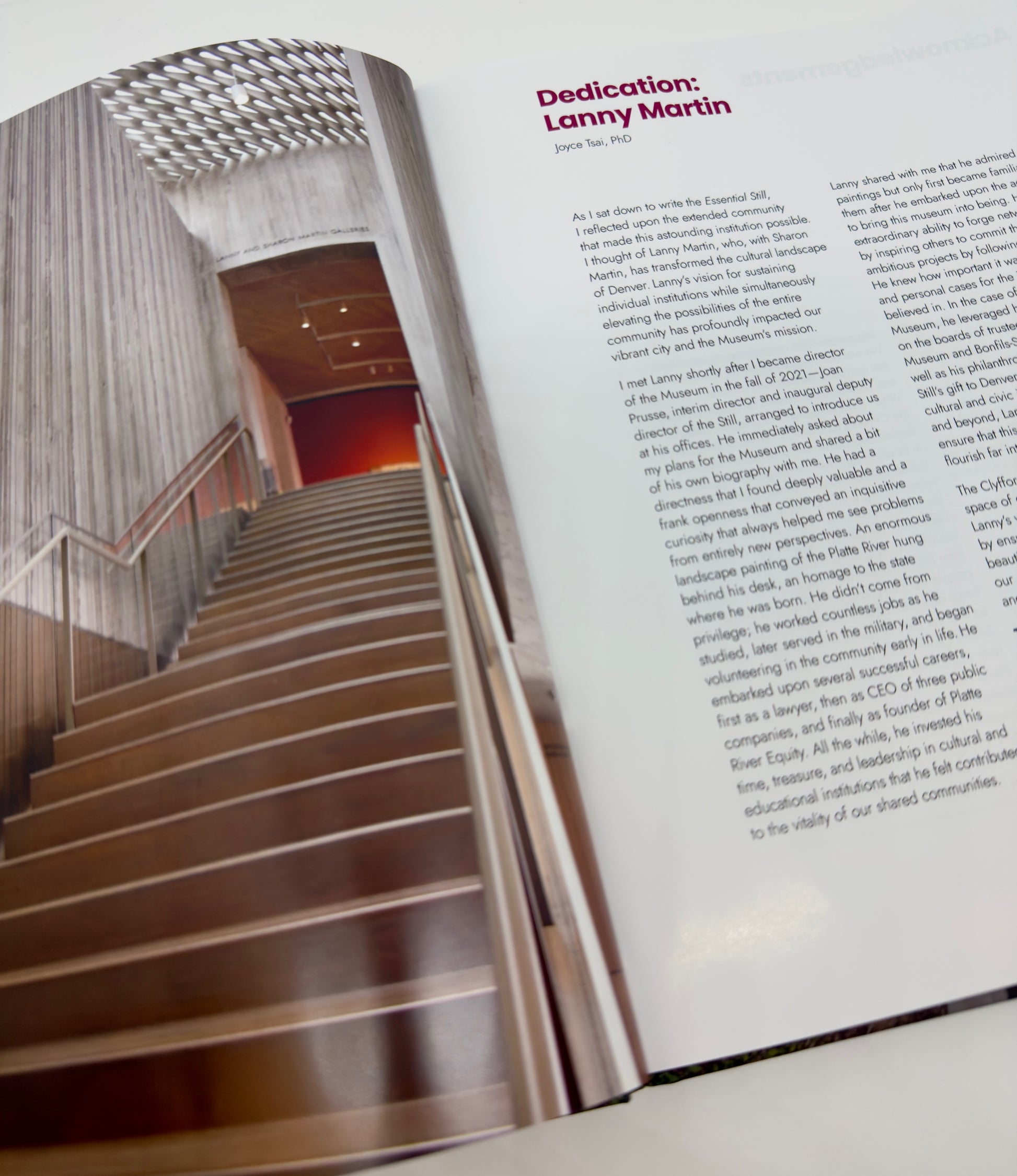 Open book showing a staircase and text on a white surface
