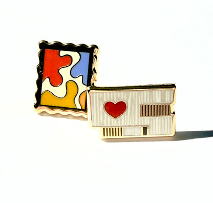 Enamel earrings of the Clyfford Still Museum building and a painting
