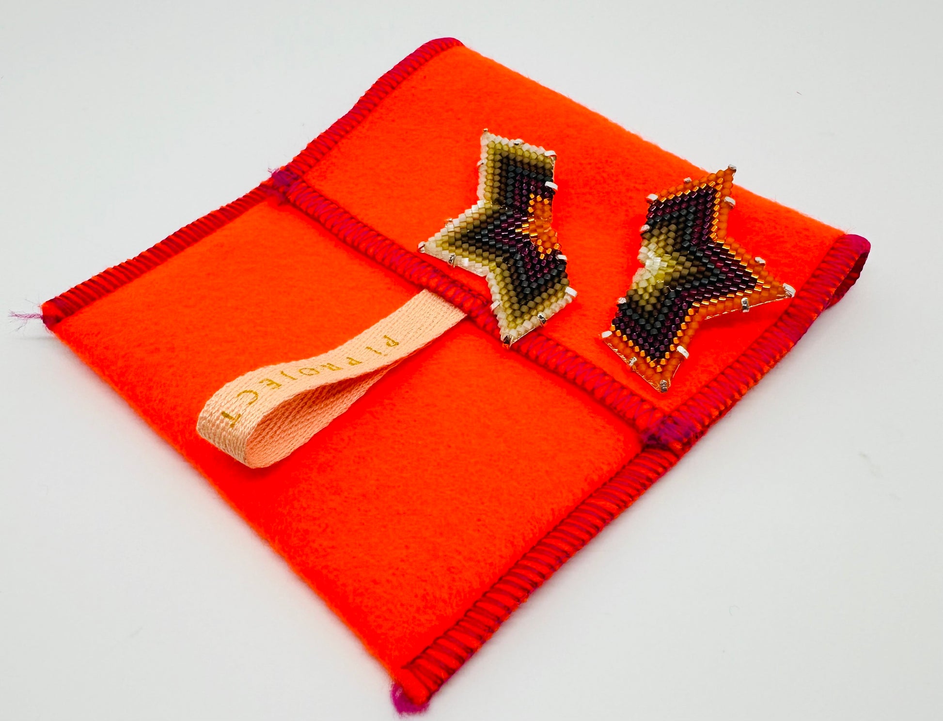 Image of Star/Orange and Tan Earrings with case.