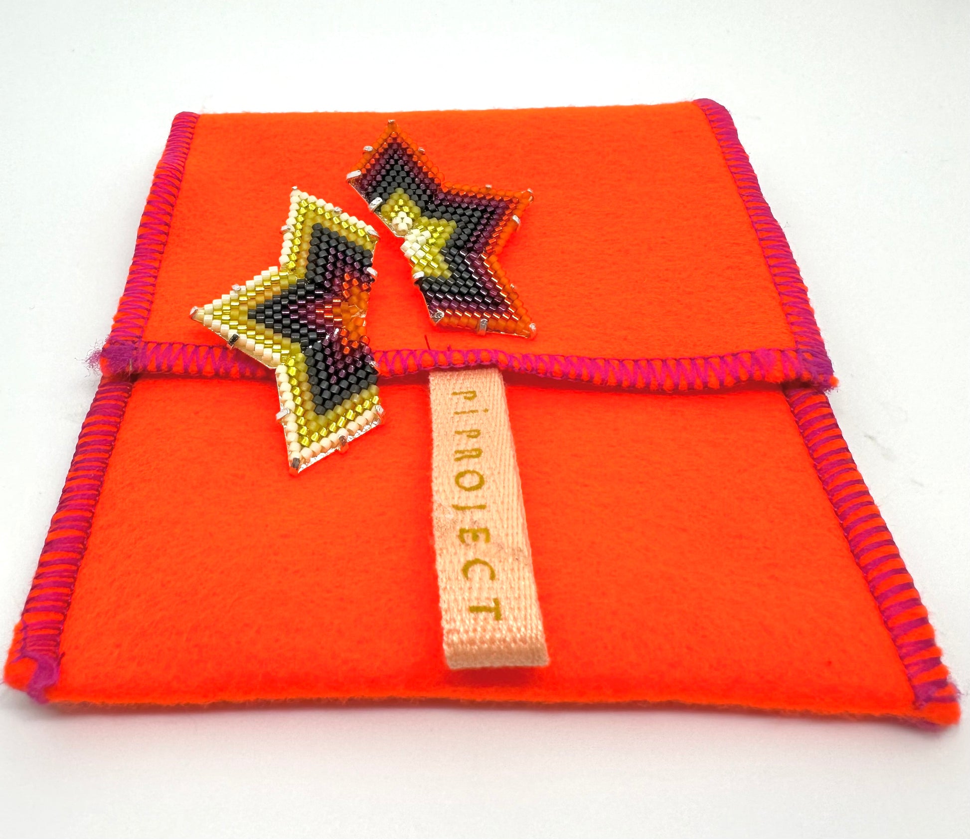 Image of Star/Yellow, Orange, and Burgundy Earrings with case.