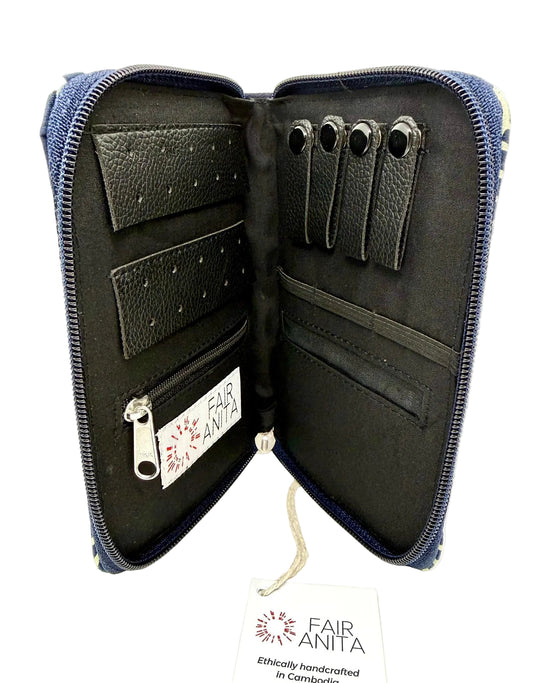 Open jewelry pouch with black exterior, featuring Fair Anita branding, on a white background.