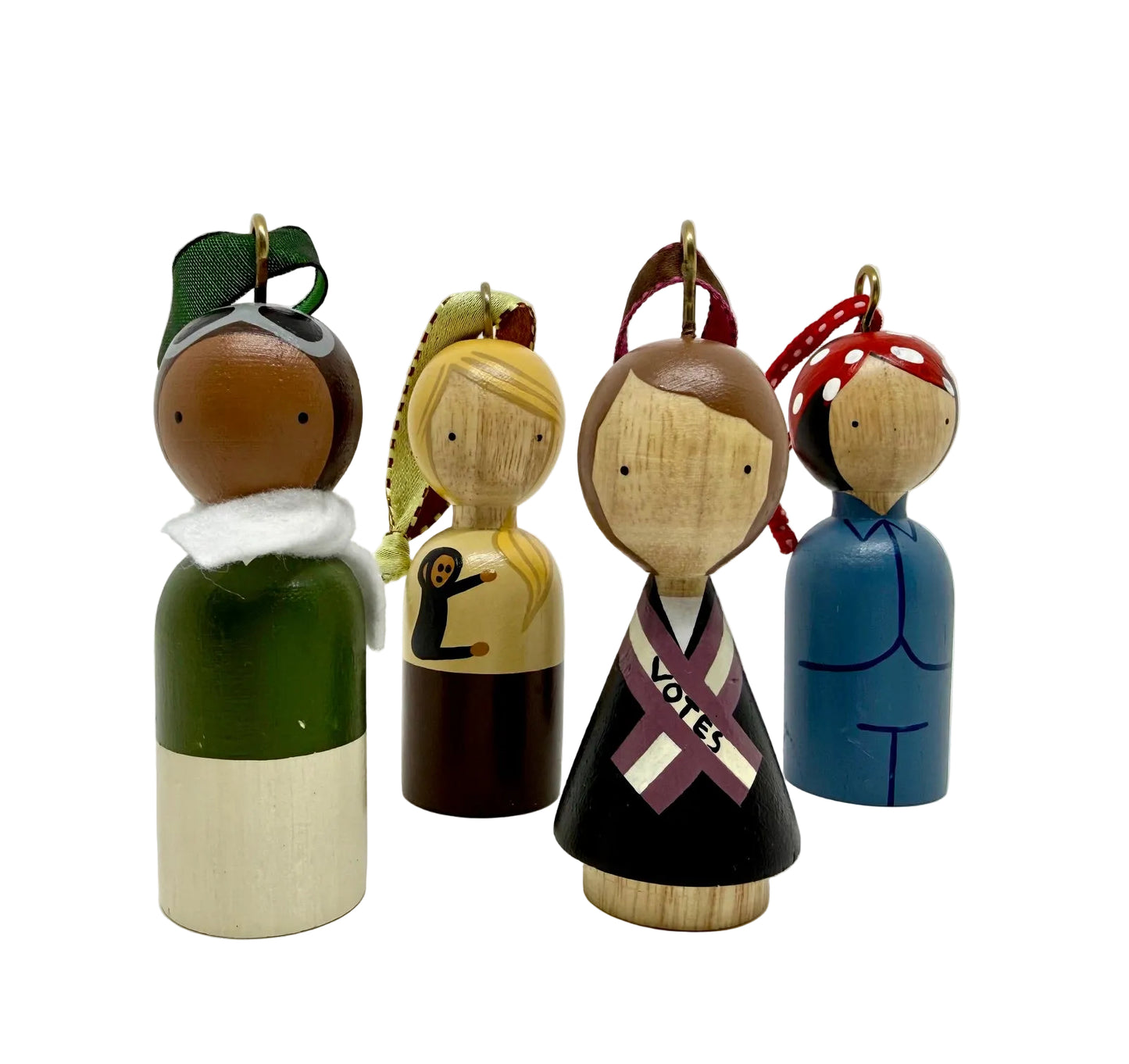 Set of four wooden peg dolls with different hairstyles and outfits on a white background.