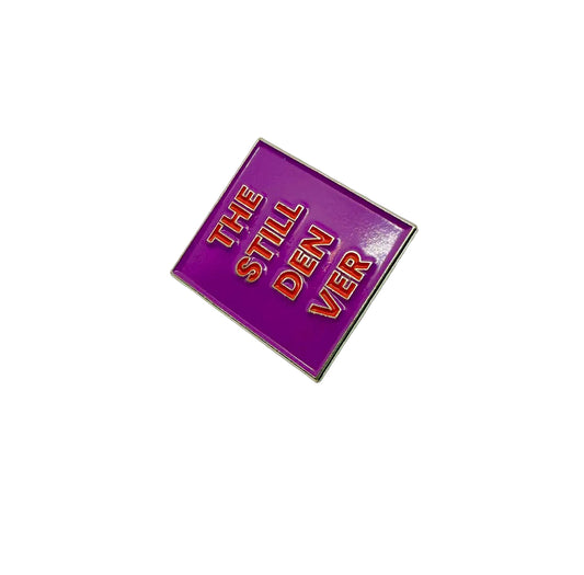 Purple pin with silver text on a white background