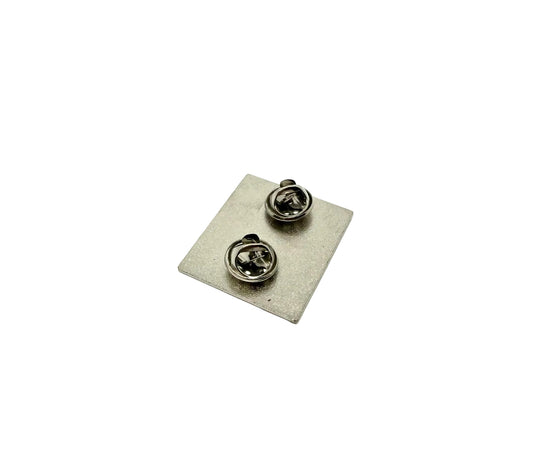 Silver back of a pin with a white background