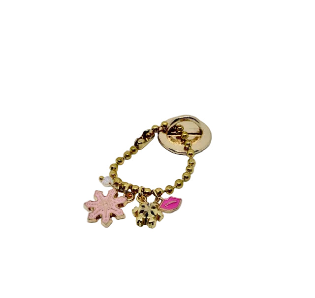 A gold-tone beaded charm keychain featuring a pink snowflake, a gold snowflake, pink kiss charm, shown on a plain white background.