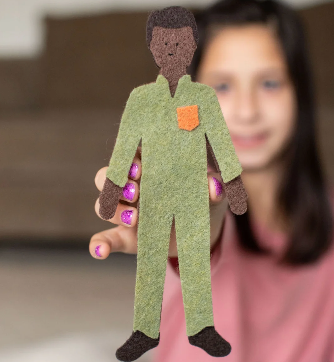 Girl holding ‘Cocoa Short Haired Felt Doll’