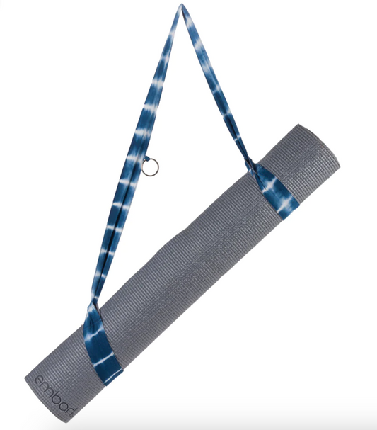 Blue Shibori Tie Dye Strap holding a rolled yoga mat.