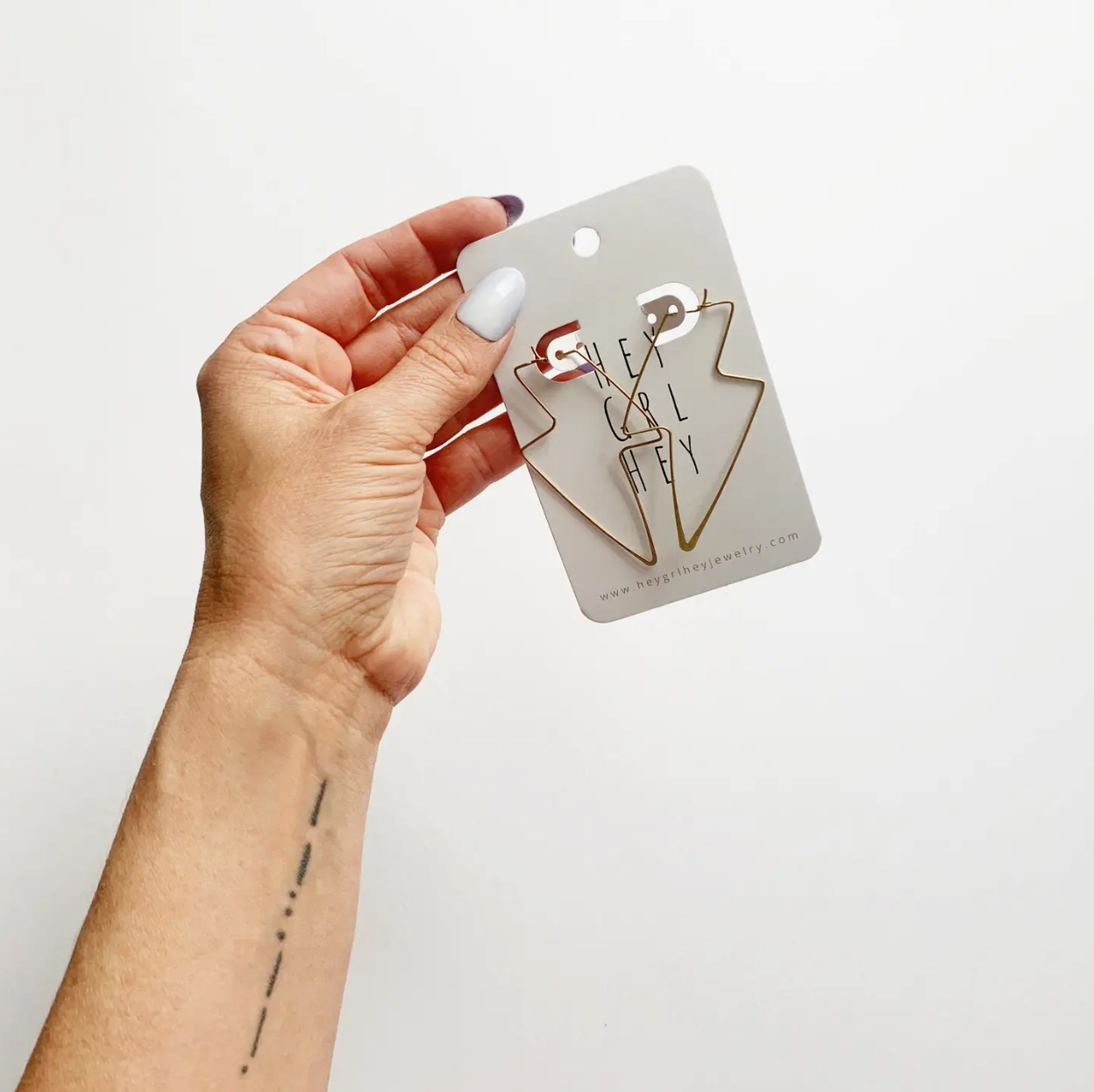 Image of Hand Holding The Lightning Hoop Earrings.