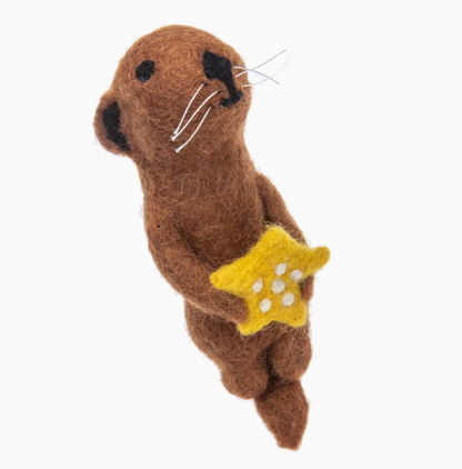 Brown plush toy otter holding a yellow star on a white background