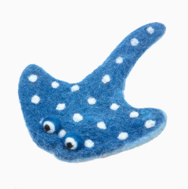 Blue felted fish with white polka dots on a white background