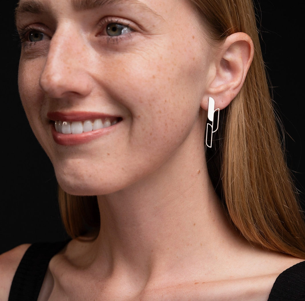 Close-up of a woman wearing gold Ascend earrings