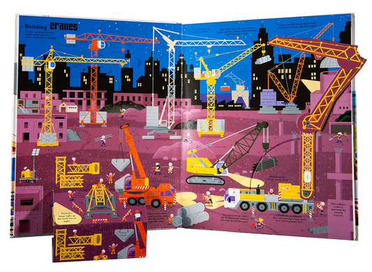 Illustrated book open to pages showing cranes and construction vehicles on a cityscape background.