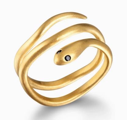 Gold snake-shaped ring with black eyes on a white background