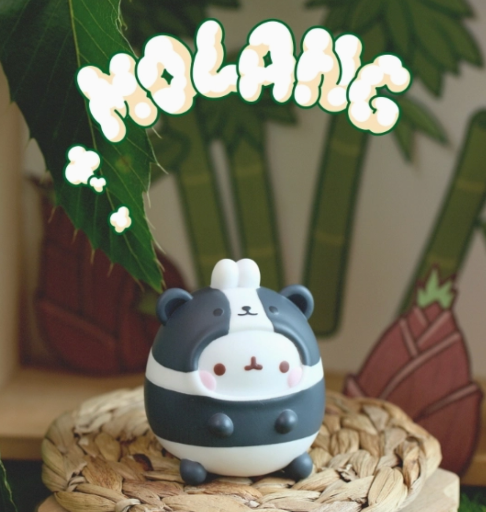 Cute panda-shaped figurine on a woven mat with 'Molang' branding.