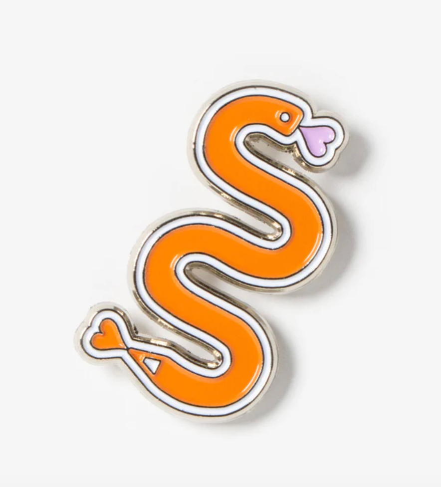 Snake-shaped enamel pin on a white background