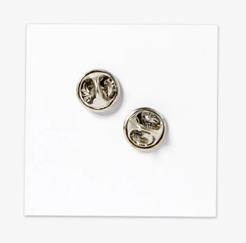 Backside of enamel pin on a white background