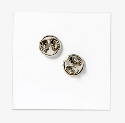 Backside of enamel pin on a white background