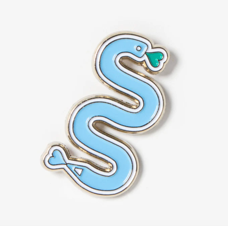 Blue snake-shaped enamel pin on a white background