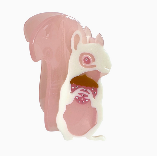 Squirrel-shaped hair clip with pink shell on a white background