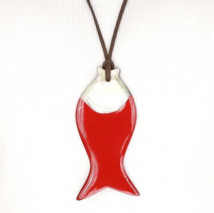 Red and white fish-shaped pendant on a brown cord against a white background