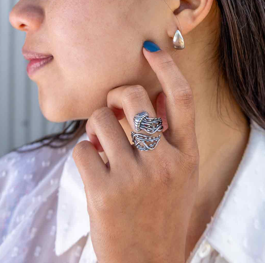 Silver jellyfish-shaped ring on finger