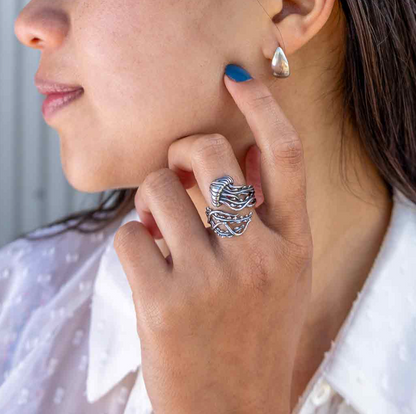 Silver jellyfish-shaped ring on finger