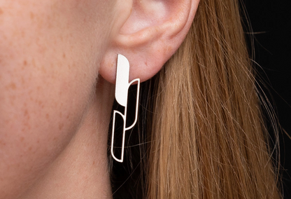Close-up of a woman wearing a gold Ascend earring 