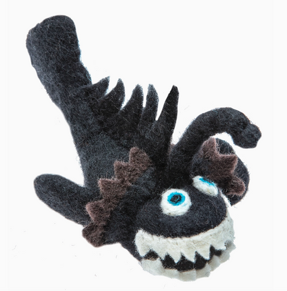 Black and white plush toy resembling a sea creature on a white background