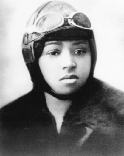 Black and white portrait of a person wearing a helmet with goggles.
