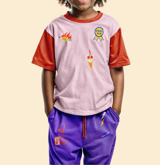 Child wearing a colorful outfit with graphics on a beige background.