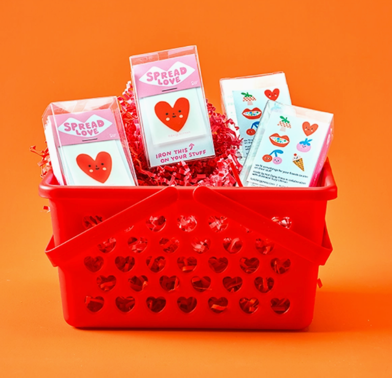 Red basket filled with heart-themed ion-on decals on an orange background.