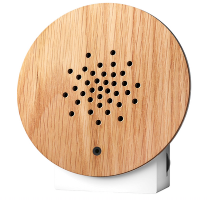 Wooden circular sound box with a white base on a white background