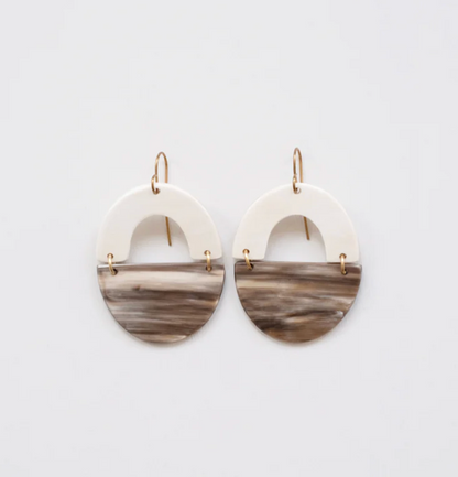Pair of earrings with marbled design on a light gray background
