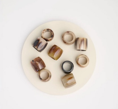 Horn tortoise colored ring-shaped bandana slides on a white plate