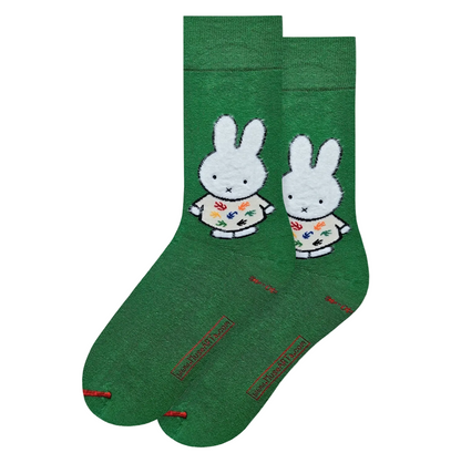 Green socks with a Miffy design on a light gray background