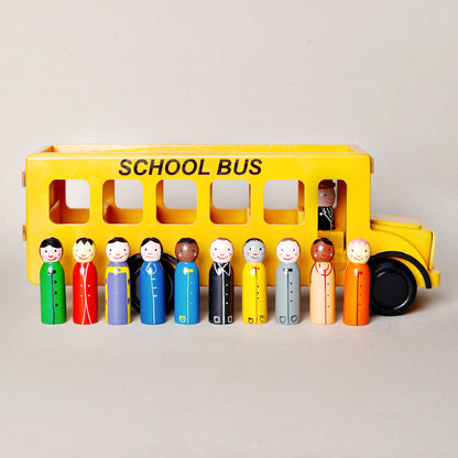 Toy school bus with peg people on a light gray background
