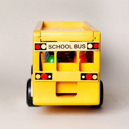 Wooden toy school bus with colorful lights on a light gray background