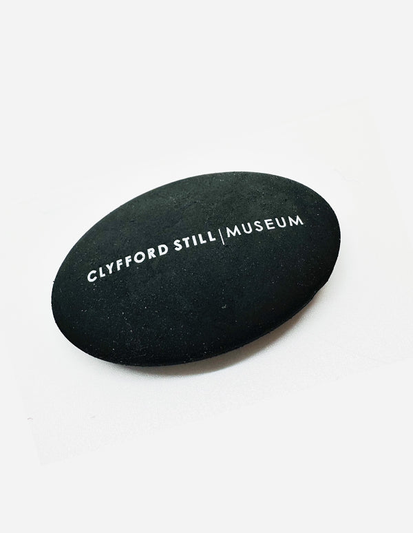 Black Pebble Eraser with Clyfford Still Museum logo.