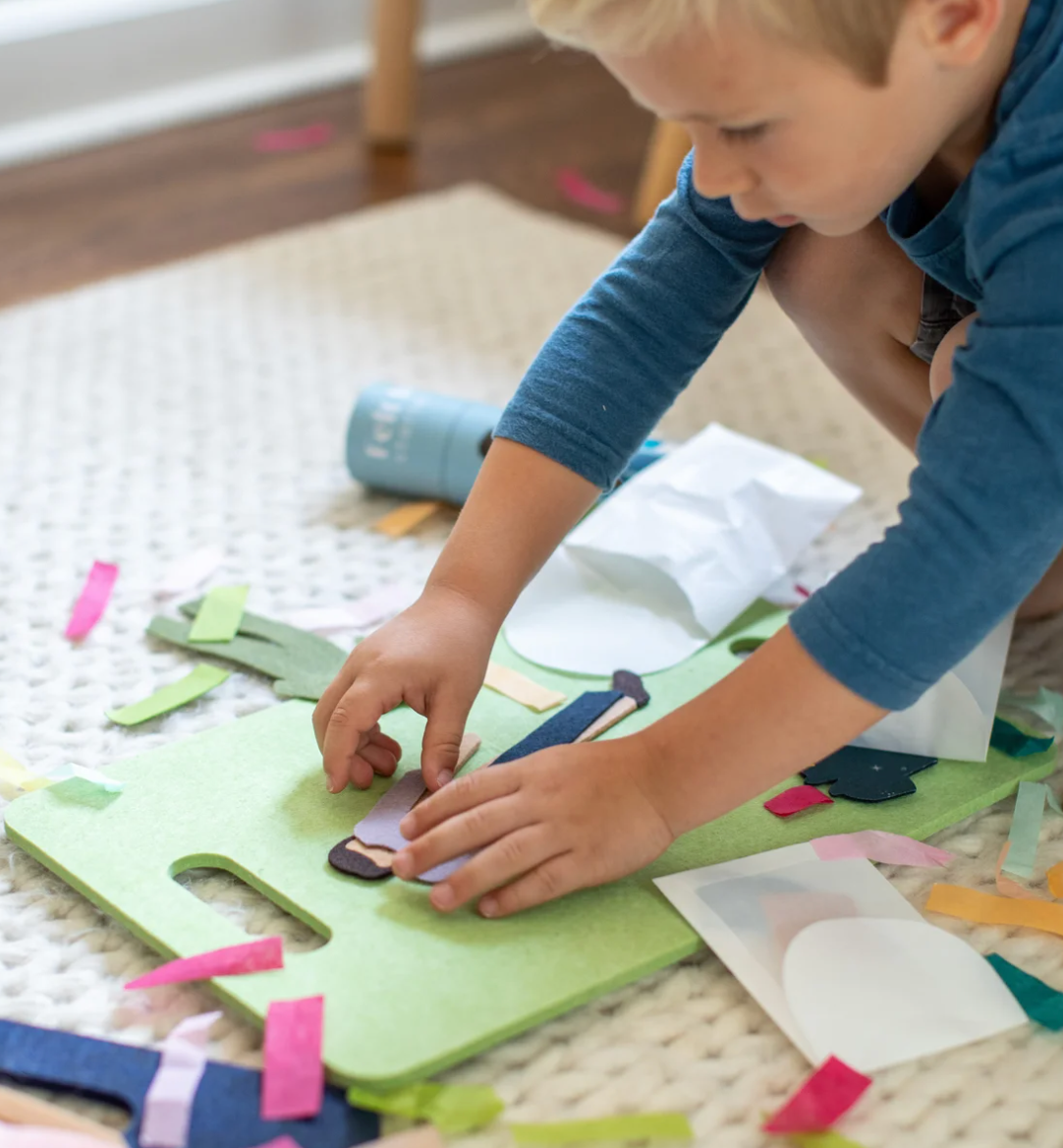 Boy playing with Felt Doll on the Travel Board